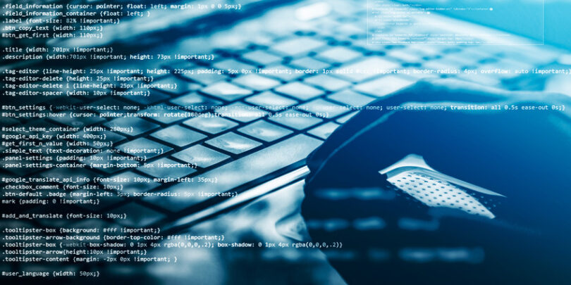 Hacker using laptop. Lots of digits on the computer screen.