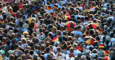 Aufsicht einer dicht gedrängten Menge von Fußballfans.