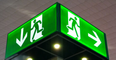 Emergency exit sign, cube light on ceiling.
