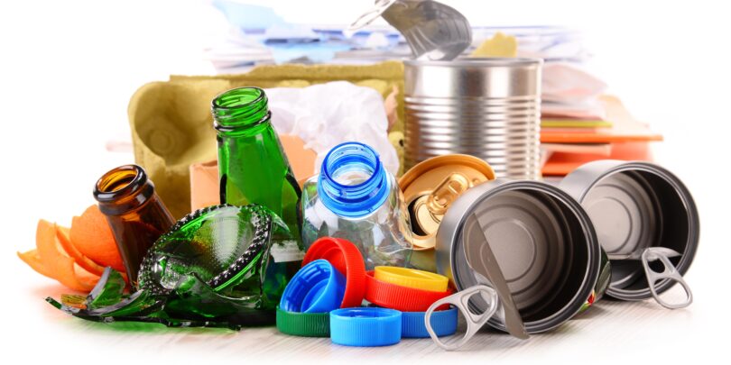 Recyclable garbage consisting of glass, plastic, metal and paper isolated on white background.