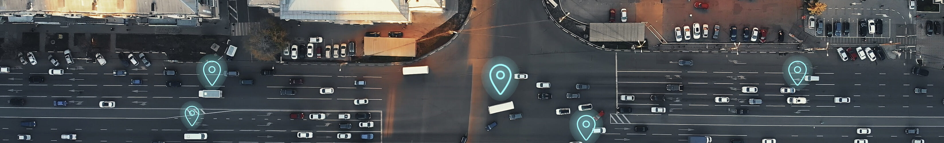 Aerial view of city intersection with many cars and GPS navigation system symbols. Autonomous driverless vehicles in city traffic.