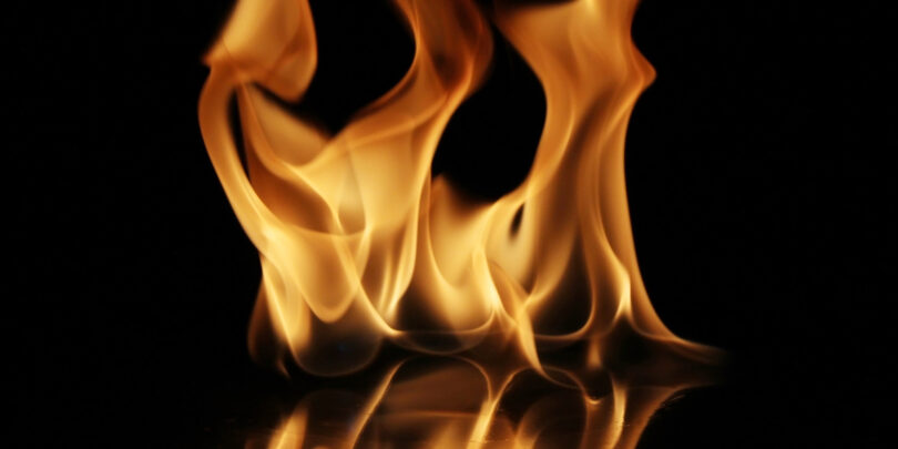 Soft Fire flame reflected on black background.